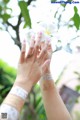 A woman holding a white flower in her hand.