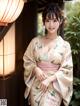 A woman in a kimono posing for a picture.